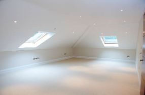 Empty converted loft with roof windows ready for finishing