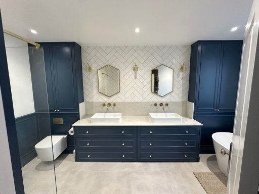 Loft ensuite with navy double vanity unit